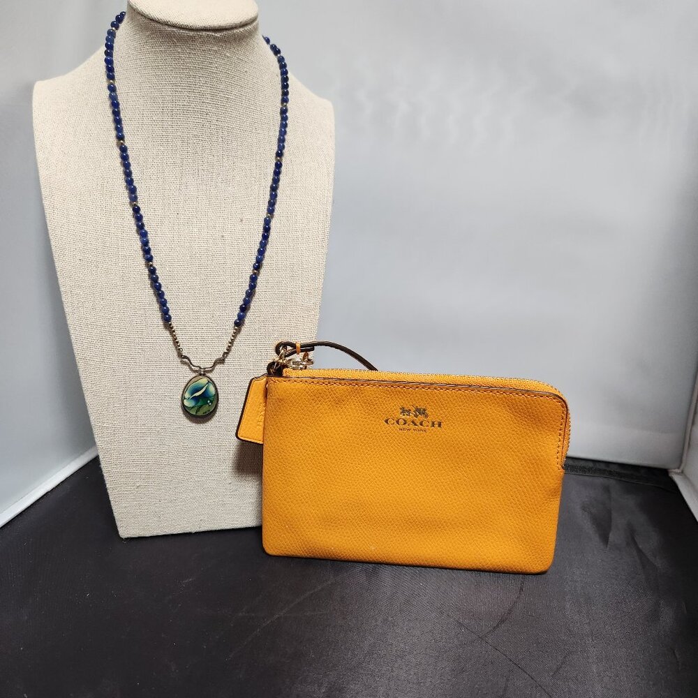 Coach corner zip wristlet in Orange Peel color w/ silver and lapis bead necklace